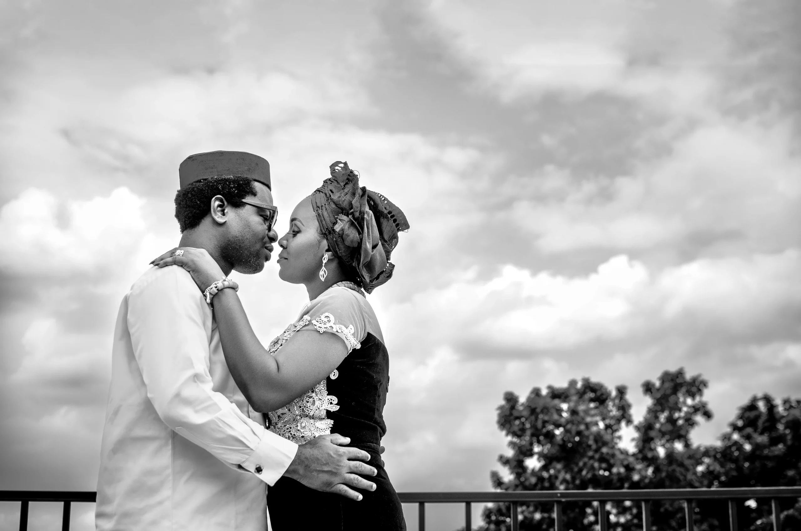 black and white portrait of a bride and groom kissing at a lagos wedding