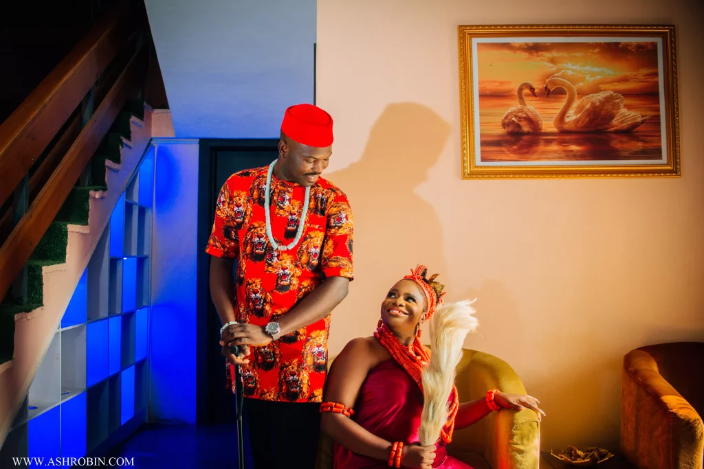 couple looking at each other and laughing at their nigerian traditional wedding