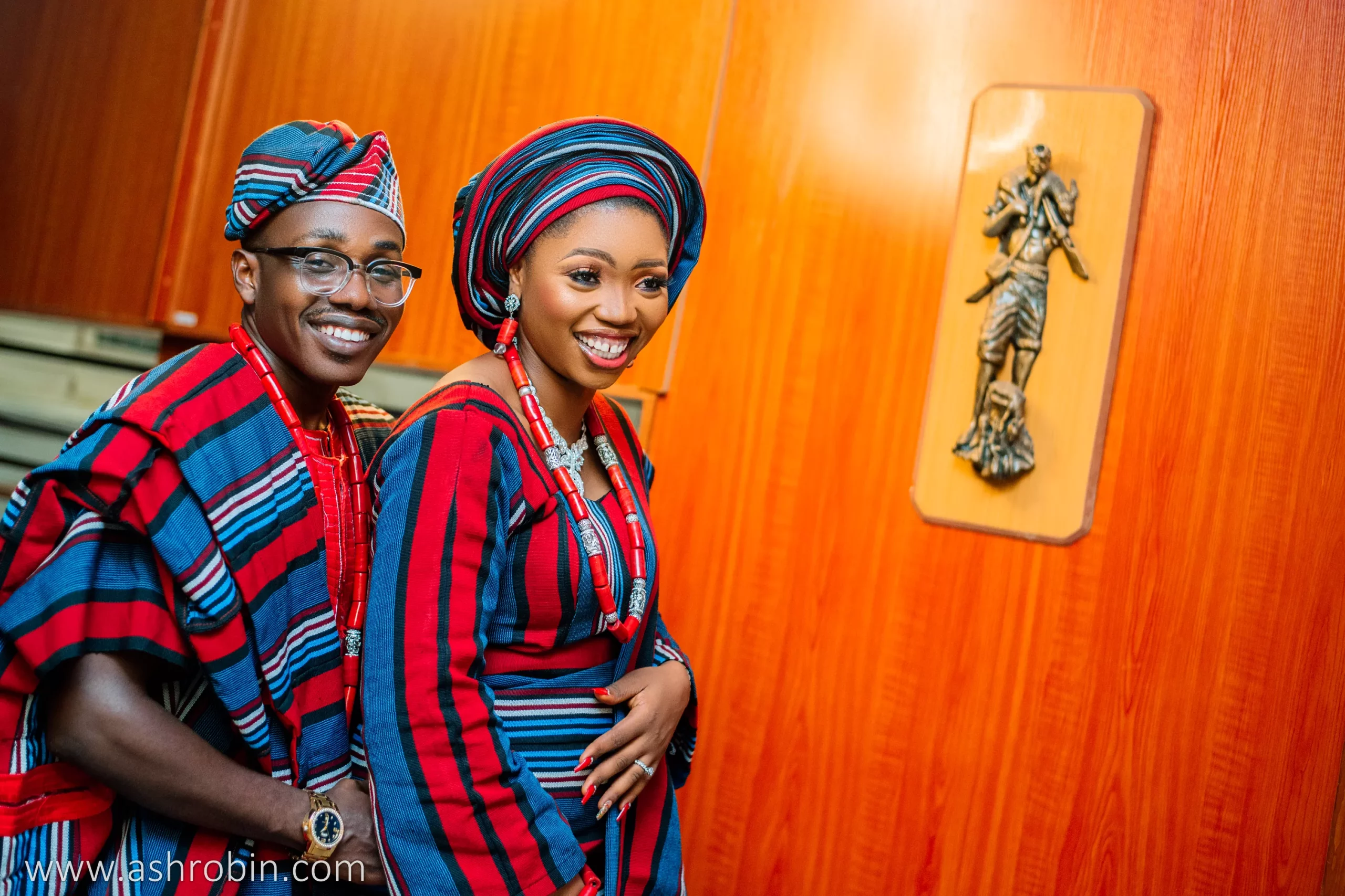 smiling portrait of a yoruba couple wearing asooke