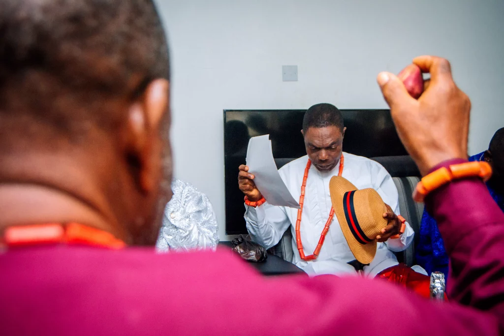 Fathers at a Nigerian wedding: one holding kola, the other holds the brideprice checklist