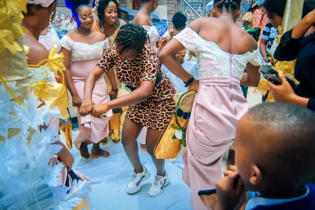 Documentary photo of guests dancing at a Nigerian wedding