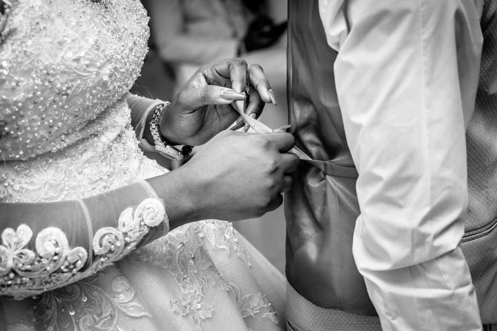 bride adjusting groom's suit at a wedding