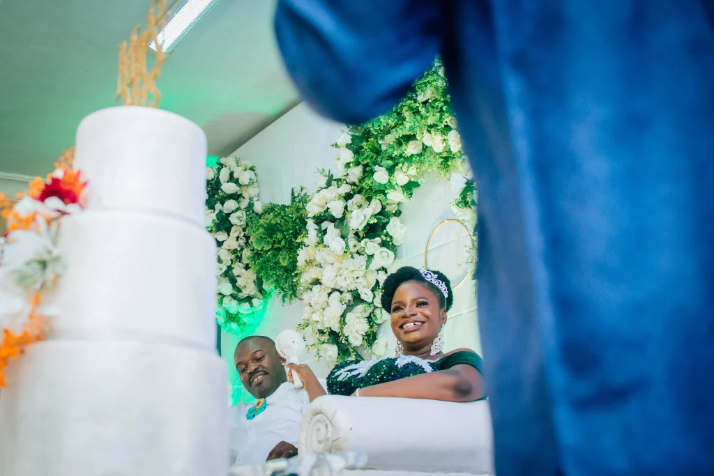 smiling couple shot through their wedding cake