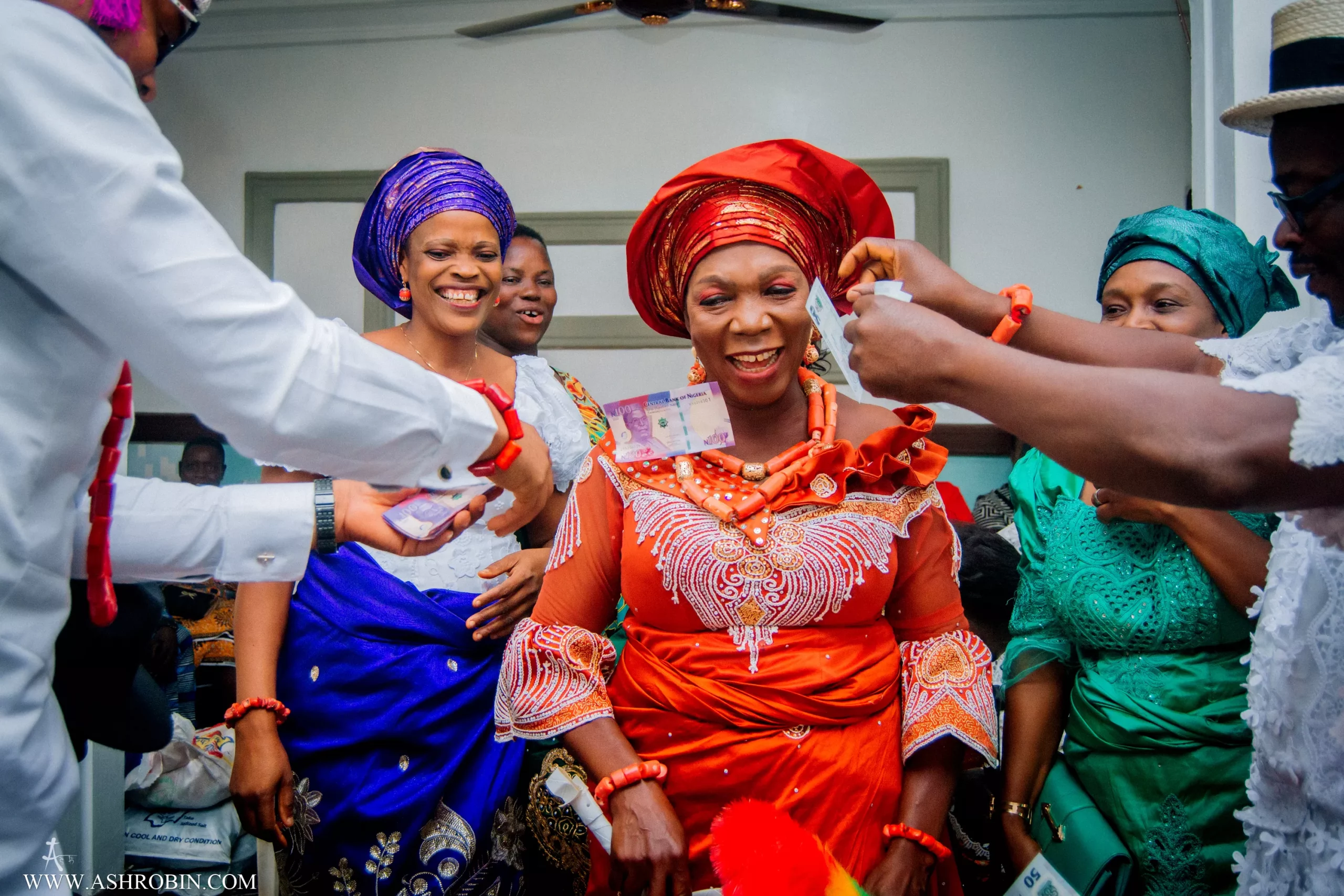 groom spraying mother in law with money at nigerian traditional wedding